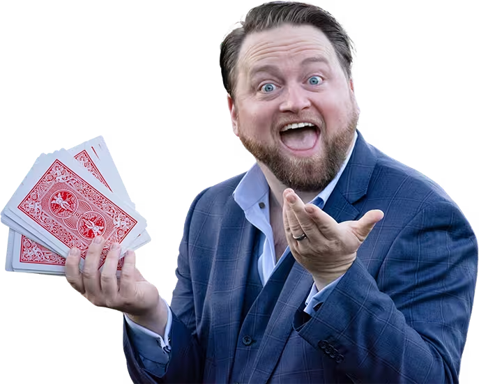 Michael Misko, grinning behind a fan of playing cards